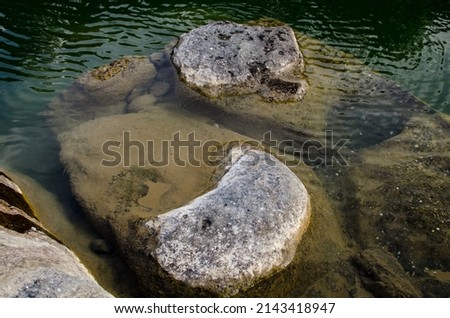 Riverside landscape with rocks in the afternoon