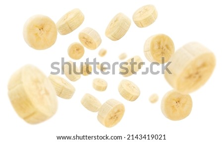 Flying banana slices, isolated on white background Royalty-Free Stock Photo #2143419021