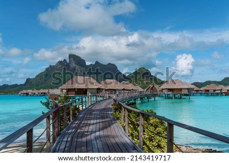 View of the Mount Otemanu through turquoise lagoon, palm trees and overwater bungalows on Bora Bora island, Tahiti, French Polynesia, South Pacific Royalty-Free Stock Photo #2143419717