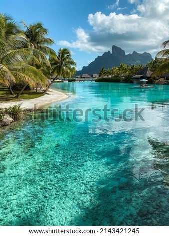 View of the Mount Otemanu through turquoise lagoon and palm trees on Bora Bora island, Tahiti, French Polynesia, South Pacific Royalty-Free Stock Photo #2143421245