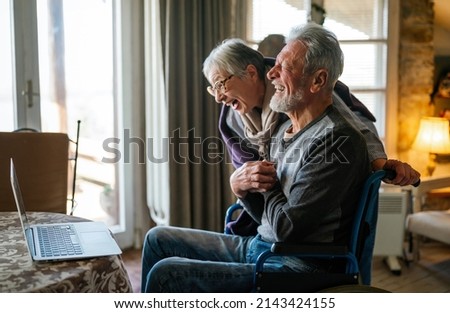 Happy romantic senior couple hugging and enjoying retirement at home