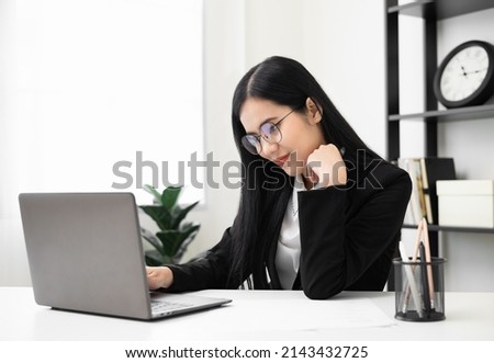 Young asian beautiful business woman working with laptop sitting at home and note on book. Smiling charming happy young female doing homework meeting conference with team at office.