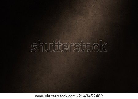 Dark warm tone photography backdrop. Concrete wall texture with lighting effect background.