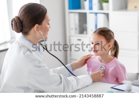 medicine, healthcare and pediatry concept - female doctor or pediatrician with stethoscope and little girl patient on medical exam at clinic Royalty-Free Stock Photo #2143458887