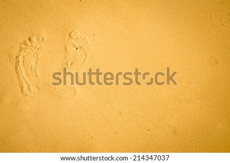 footprint printed in yellow sand