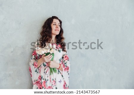 brunette woman in a summer dress with flowers