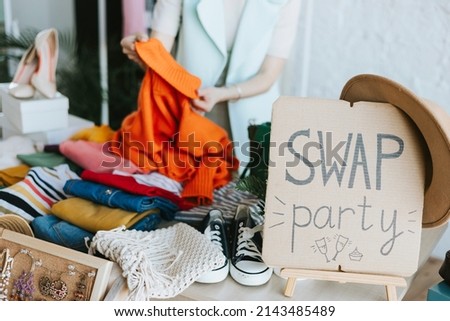 middle aged woman female woman at swap party try on clothes, bags, shoes and accessories, change clothes, second hand garment, zero waste life, eco-friendly approach to consumption, diverse people Royalty-Free Stock Photo #2143485489