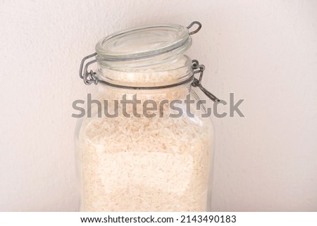 raw white rice in glass jars with sealed lids, the concept of food strategic stocks for a rainy day, food supplies for cooking, ecological packaging, pest control