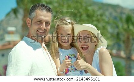 Young mother and father loving their little daughter. Happy family enjoying vacation. Happy family portrait. 