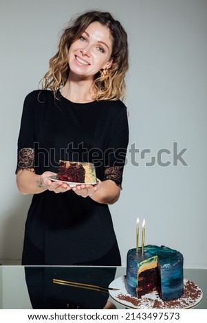a woman cuts a sweet birthday cake