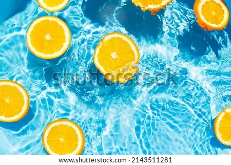 Creative summer composition made of sliced orange in transparent pool water. Refreshment concept. Healthy refreshing drink theme. Top view Royalty-Free Stock Photo #2143511281