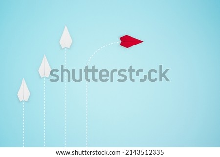 Red paper plane out of line with white paper to change disrupt and find a new way on the blue background. Elevate and create business New ideas for technological innovations