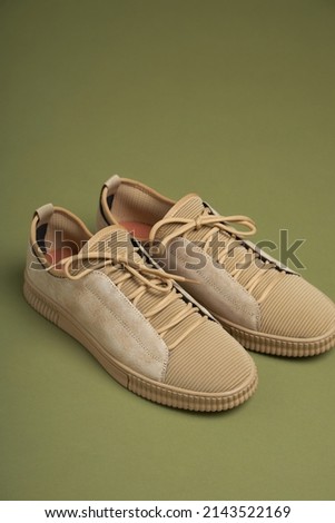 Fashion men’s pastel shoes on green background. Fashion shoes made of eco-leather spring-summer 2022.