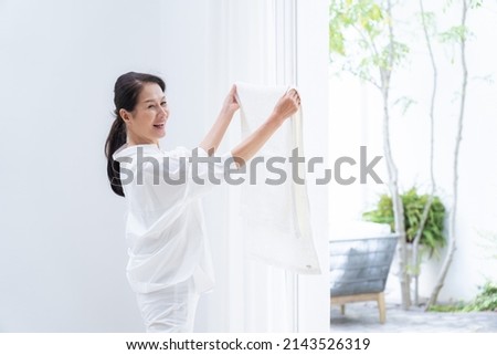 Asian senior woman drying towels Royalty-Free Stock Photo #2143526319