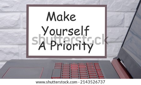 Writing note showing Make Yourself A Priority. Business photo showcasing Think in your own good first demonstratingal development Blank notepads marker rubber band alarm clock clip colored background.