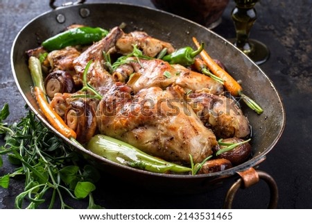 Braised Rabbit with Vegetable and Mushrooms offered as closeup in a Casserolle Stewpot