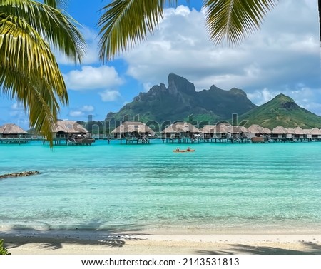 View of the Mount Otemanu through turquoise lagoon , palm trees and overwater bungalows on Bora Bora, Tahiti, French Polynesia, South Pacific Royalty-Free Stock Photo #2143531813