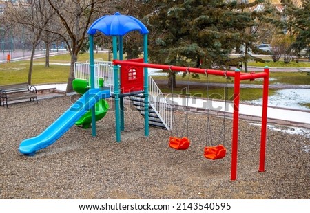 colorful swing and slide. playground with no one.