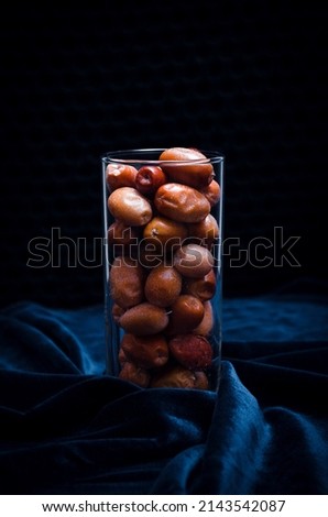 Dried fruits in a glass on a dark background. Stock photo