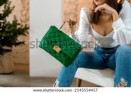 Trendy outfit woman with black bag. Girl with bag over his shoulder outdoors. Shoulder Bags for Women. Fashion look woman outfit. Stylish women's beige handbag. Close-up. Royalty-Free Stock Photo #2143554457