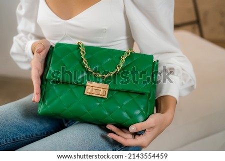 Trendy outfit woman with black bag. Girl with bag over his shoulder outdoors. Shoulder Bags for Women. Fashion look woman outfit. Stylish women's beige handbag. Close-up. Royalty-Free Stock Photo #2143554459