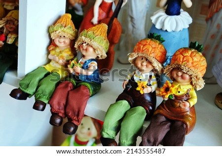 Souvenir toys and vintage resin children boy doll and retro kid girl figurine and friends figure on shelf for show in local gift shop for thai people visit and select buy in Bangkok, Thailand