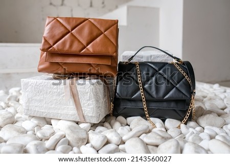 Stylish women's brown handbag. Trendy outfit woman with brown bag. Girl with bag over his shoulder outdoors. Shoulder Bags for Women. Fashion look woman outfit. Close-up. Royalty-Free Stock Photo #2143560027