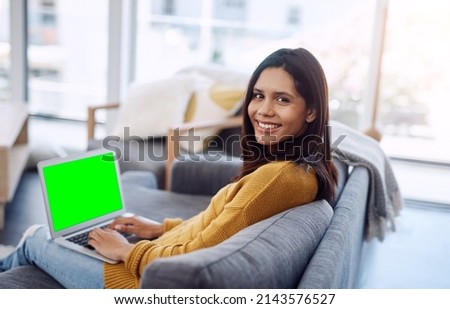 I hope everyone else is enjoying their weekend. Portrait of an attractive young woman using her laptop while relaxing on a sofa at home.