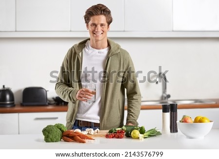 Making sure he stays healthy and nourished. Portrait of a young man preparing dinner.