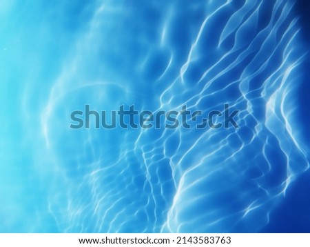 Blur​ abstract​ of​ surface​ blue​ water. Abstract​ of​ surface​ blue​ water​ reflected​ with​ sunlight​ for​ background. Blue​ sea. Blue​ water.​ Water​ splashed​ use​ for​ graphic​ design. Water​ Royalty-Free Stock Photo #2143583763