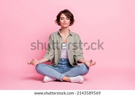 Full body photo of pretty focused lady sit lotus position meditate mudra fingers isolated over pastel color background Royalty-Free Stock Photo #2143589569
