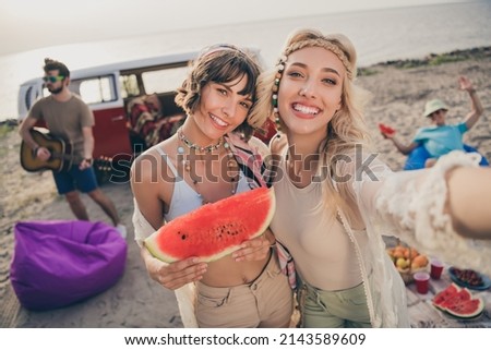Photo of carefree hippie ladies make selfie hold morning tasty breakfast watermelon outside countryside company fellows