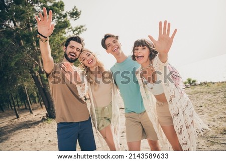 Photo of four friendly buddies make remote zoom video call wave hand wear casual outfit nature seaside beach outside Royalty-Free Stock Photo #2143589633