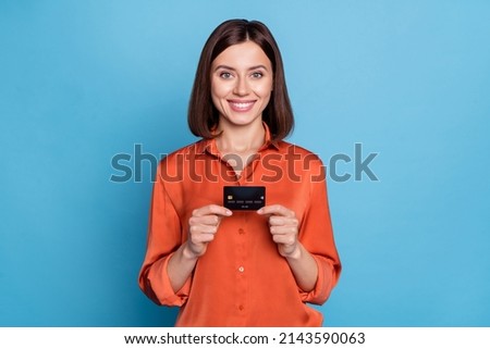 Photo of young pretty woman hold bank card income benefit salary recommend isolated over blue color background