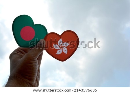 Hand holds a heart Shape Bangladesh and Hong Kong flag, love between two countries