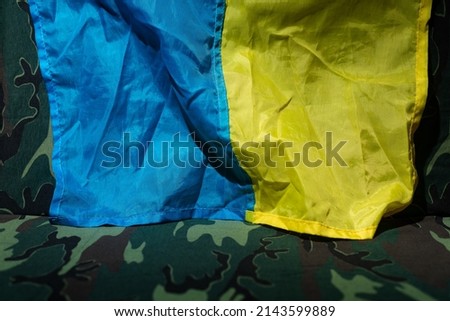 Ukraine flag and military uniform of ukrainian soldier