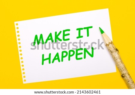 On a bright yellow background, a large wooden pencil and a white sheet of paper with the text MAKE IT HAPPEN