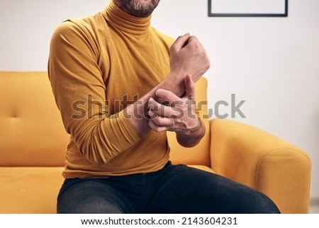 Adult man with hand, arm and wrist itchiness.