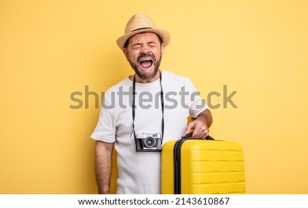 middle age man tourist shouting aggressively, looking very angry. travel concept Royalty-Free Stock Photo #2143610867