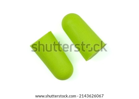Soft light green foam earplugs on a white background. Close-up.The concept of getting rid of noise in a loud place, hearing protection.High quality photo