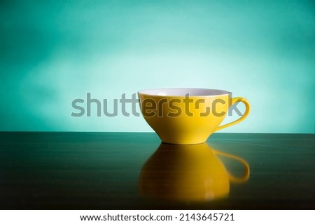 yellow and green tea cups on the table