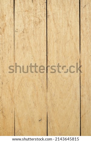 The texture of the sand-colored wooden surface with vertical lines. Texture and background. High quality photo