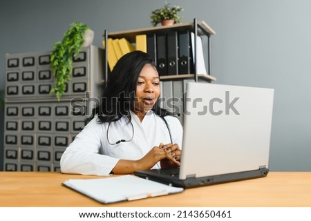 healthcare, medical and technology concept - african female doctor with laptop. Royalty-Free Stock Photo #2143650461