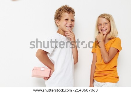 Boy and girl holiday friendship with a gift lifestyle unaltered
