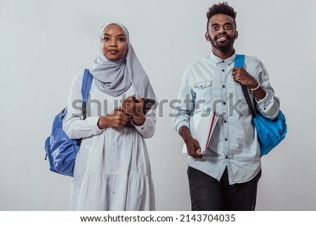Young African students couple walking woman wearing traditional Sudan Muslim hijab clothes business team isolated on white background. High-quality photo