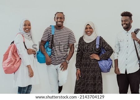 Photo of a group of happy african students talking and meeting together working on homework girls wearing traditional Sudanese Muslim hijab