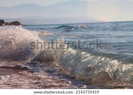 Splashing waves of a blue sea on a summer day. Selective focus. High quality photo Royalty-Free Stock Photo #2143735419