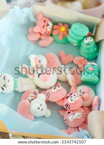 Cute colorful green, pink marshmallow pfrog, cat, bunny in gift box. Cooking funny food with cartoon character. Handmade easter pastry concept. Close up, trendy sweetness for coffee, cocoa