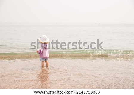 a child playing on the beach