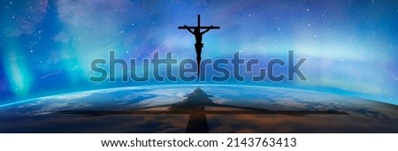 Jesus on the cross over the clouds with aurora borealis (Northern lights), jesus shadow on the Planet Earth "Elements of this image furnished by NASA"